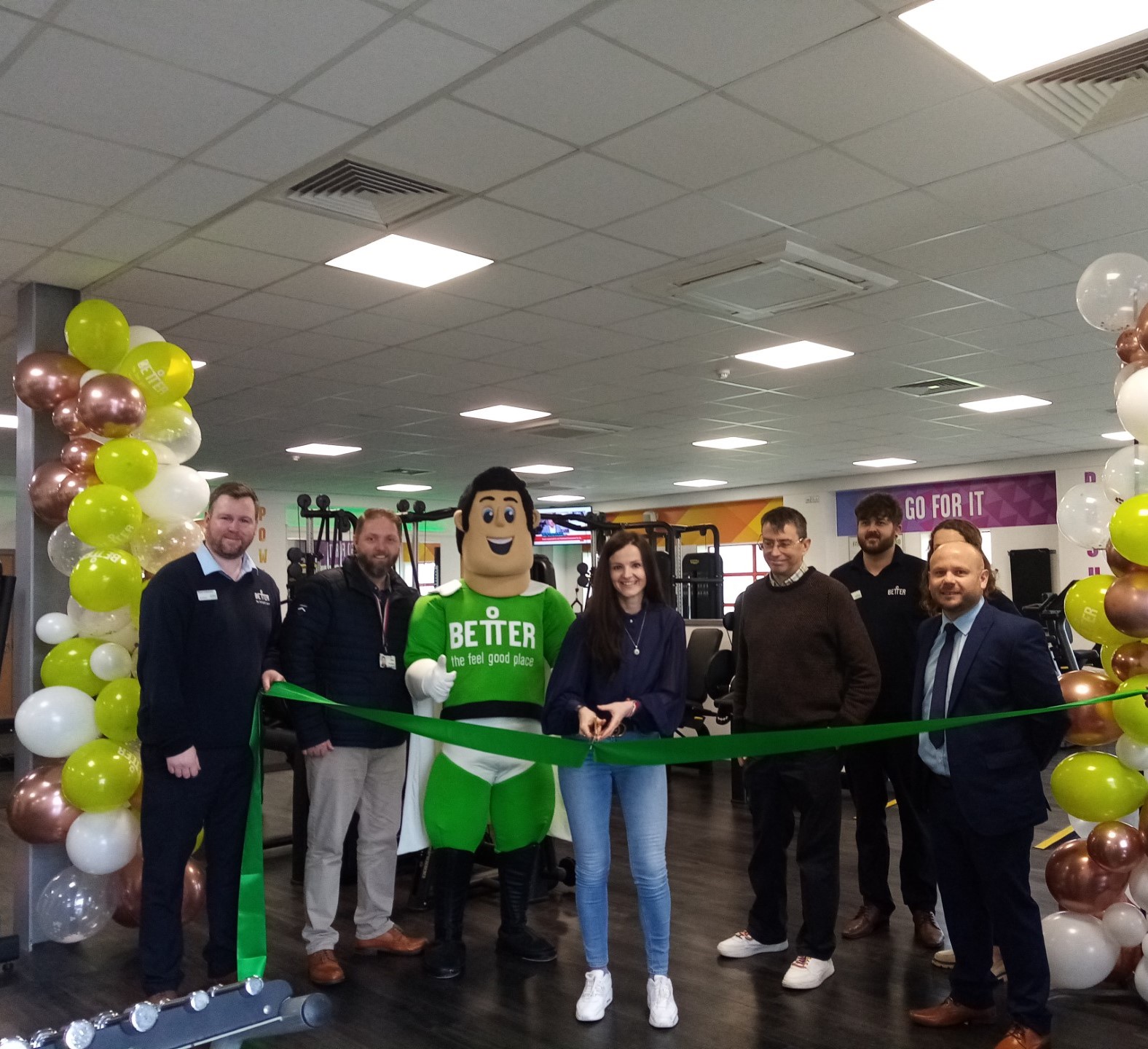 Cllr Maggie Filipova-Rivers cutting the ribbon with Cllr David Rouane, council staff, Better Man, and staff from Didcot Wave.