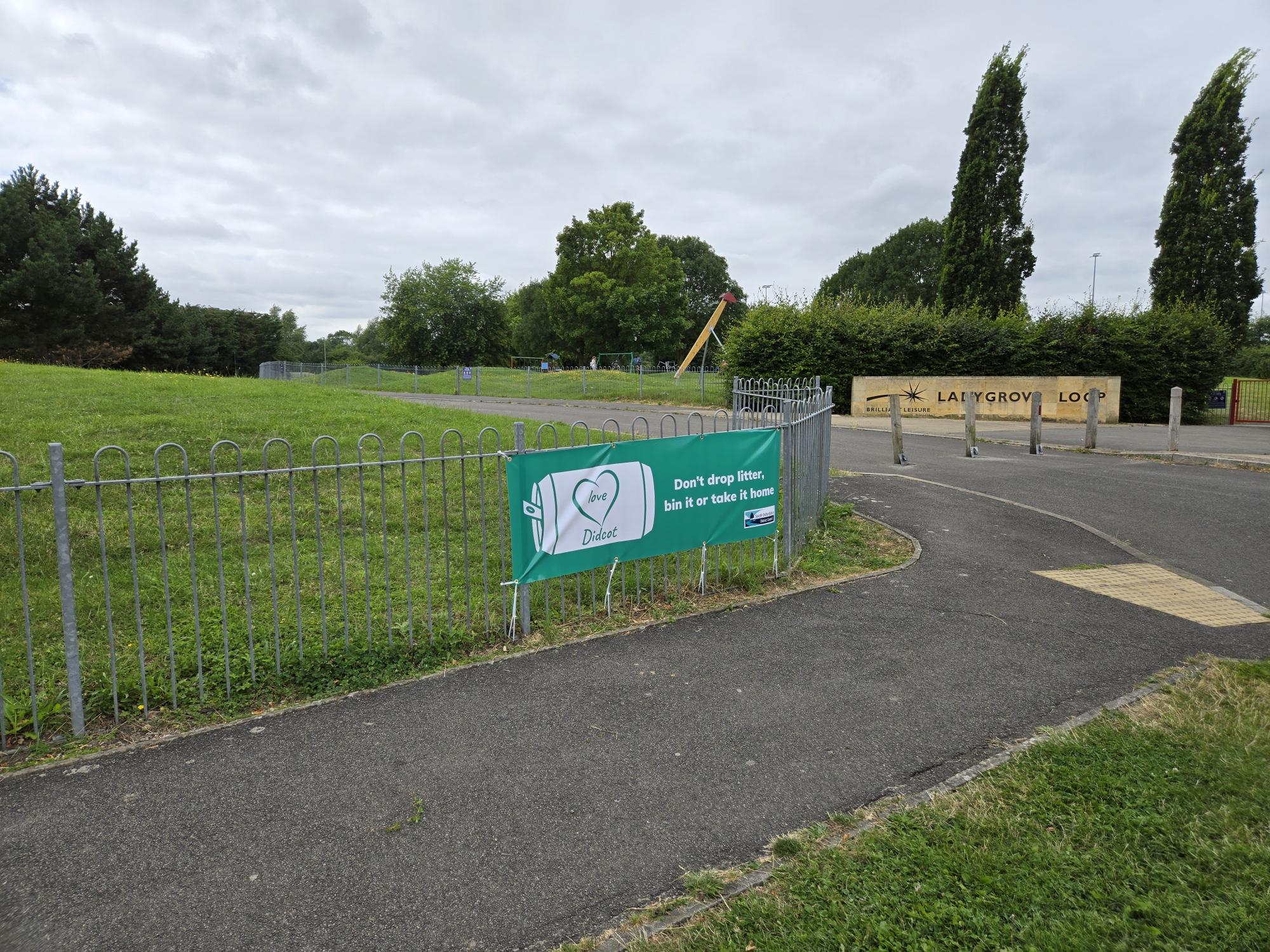 A photo of a banner on the railings at Ladygrove Loop in Didcot saying Love Didcot - don't drop litter, bin it our take it home