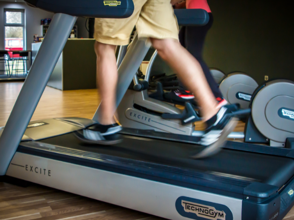 Person in a gym with a treadmill