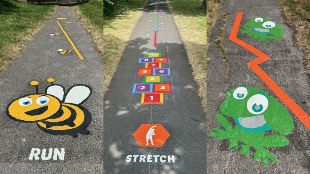 Three pictures of the Didcot Nature Trail: A section of a pathway is enlivened with a playful painting of a large, yellow and black bee with white wings and friendly blue eyes. Below the bee, the word ‘RUN’ is painted in bold capital letters, surrounded by smaller symbols like arrows and footprints, creating an inviting track for running or walking that promotes physical activity in an engaging manner. A vibrant hopscotch game painted on a park pathway, featuring numbered squares from 1 to 10 in various colours. The word ‘STRETCH’ is prominently displayed in an orange semicircle at the start, accompanied by an icon of a person stretching, suggesting a fun and active play area. Two playful green frog illustrations adorn a concrete pathway, connected by an orange zigzag line. The larger frog at the bottom greets passersby with wide, happy eyes, while the smaller frog at the top shares the same cheerful expression, creating an inviting and fun atmosphere along the walkway