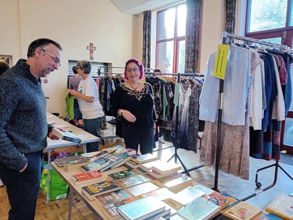 Cllr Mark Coleman browsing books at the Sustainable Didcot clothes and book swap