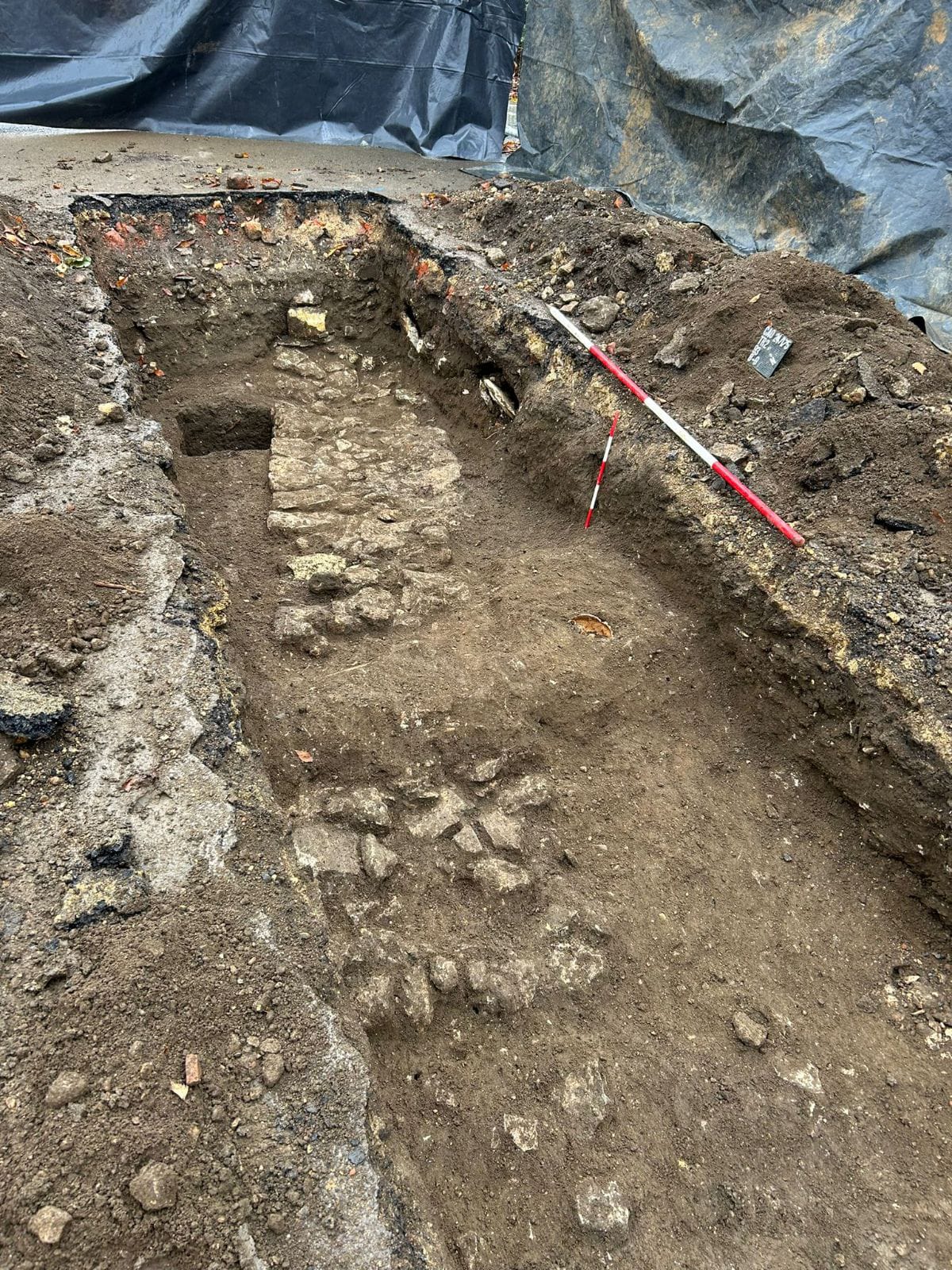 Archaeological trench showing signs of an old wall in the ground