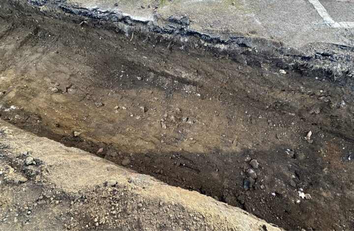 Archaeological trench showing signs of an old wall in the ground