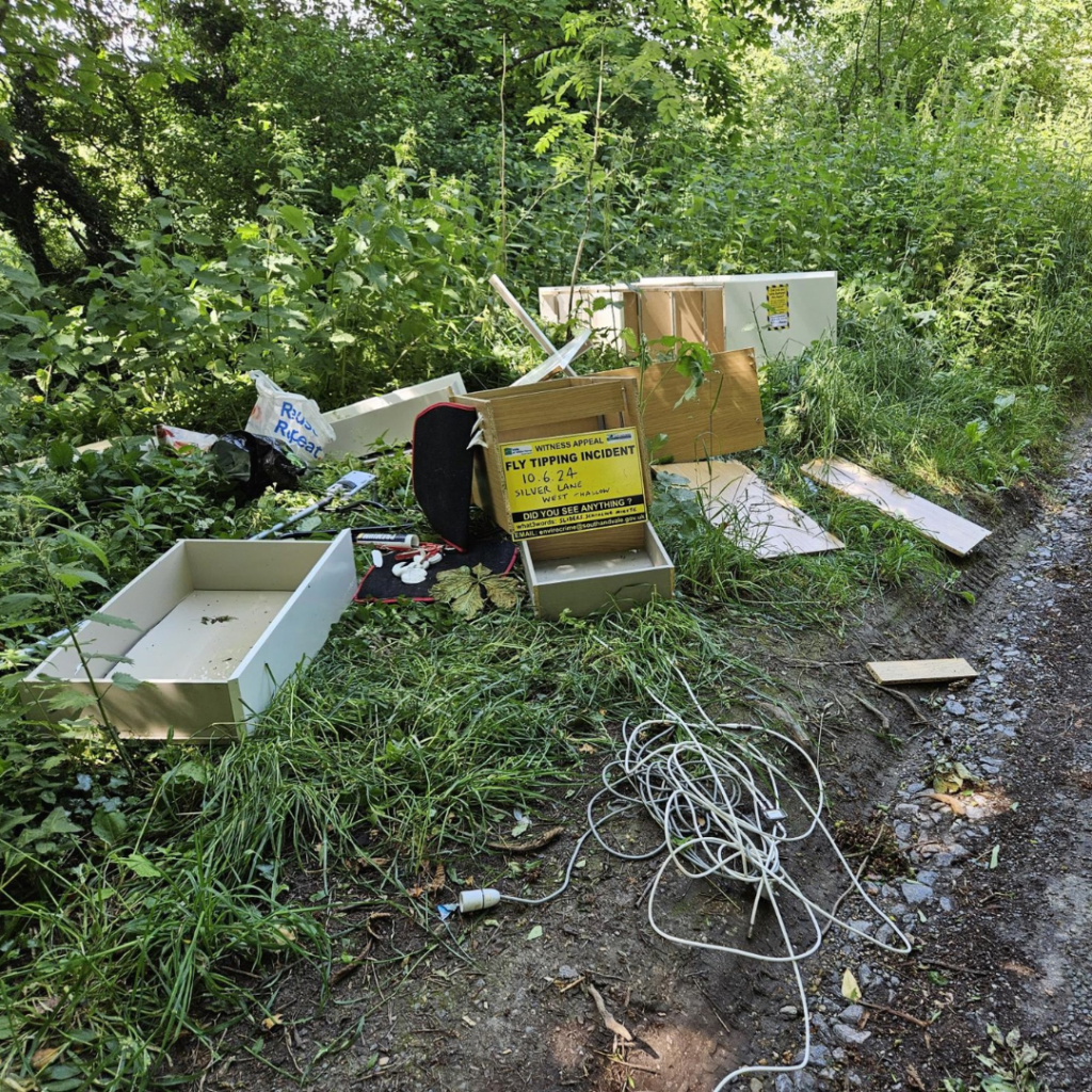 A photo of dumped rubbish including drawers, shelving, chairs and wiring